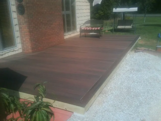 Freshly stained wood deck built against a brick home in Ovid